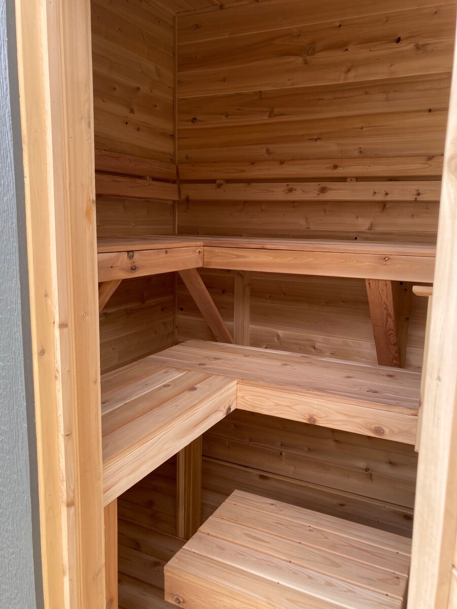 Corner view of cedar sauna benches and backrest